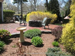 Antique red brick patio with a natural stone fire pit